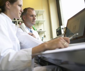 Two doctors looking at computer screen, low angle view