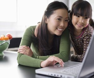 Mother and daughter using laptop computer