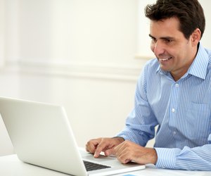 Alone adult businessman working on his laptop