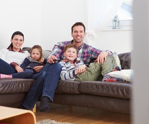 Family Relaxing Indoors Watching Television Together