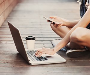 Girl using a laptop and smart phone