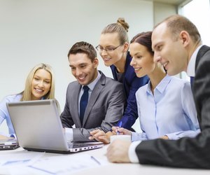 business team with laptop having discussion