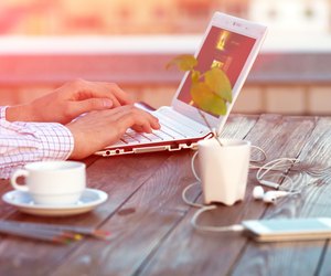 Freelance work at wood Table located on outdoor terrace