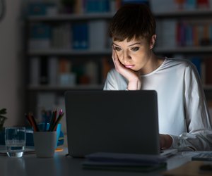 Woman using a laptop late at night