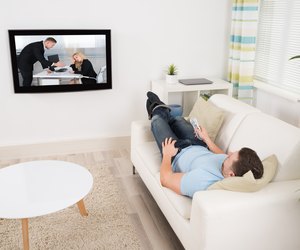 Relaxed Man Watching Movie In Living Room