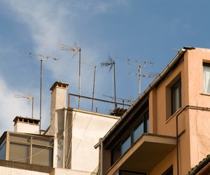Chimneys and antennae on roof of building in Spain