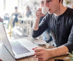 Young hipster man drinking his coffee in a cafe bar