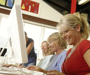 Two mature women and one senior woman in computing class