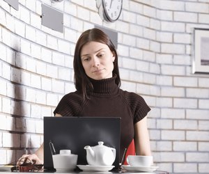 Young woman using laptop in cafe