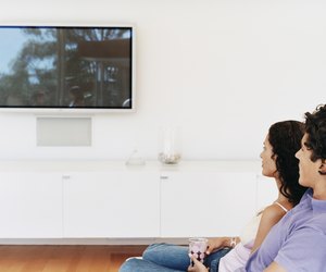 Couple Watching a Flat Screen TV in Their Home