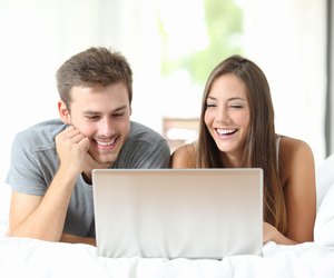 Couple watching videos on a laptop at home