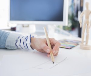 Female hands drawing with pencil