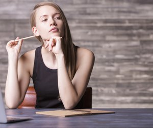 Thoughtful girl with pencil