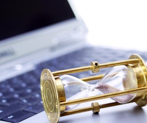Close up of an hour glass on a laptop