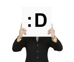 Businessman hold board with smile face emoticon