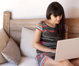 Young smiling woman using a laptop