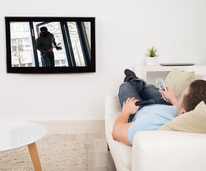 Man Watching Movie On Television In Living Room