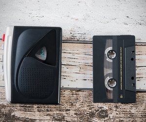 Old tape player, recorder and casette on wooden background