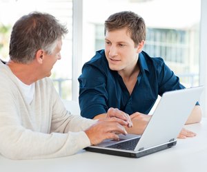 Two businessman working on their laptop