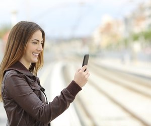Woman browsing social media in a train station
