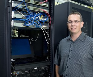Portrait of a technician standing in a server room