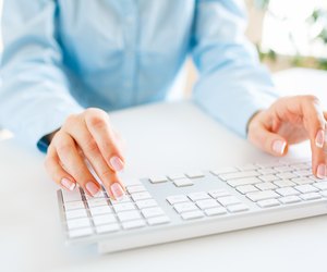 Woman office worker typing on the keyboard