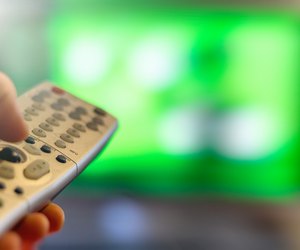 Close-up of TV remote control over a blurred background