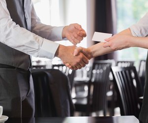 Busines people shaking hands after meeting and changing cards