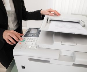 Businesswoman Pressing Printer's Button