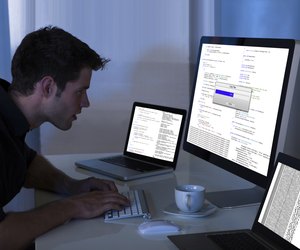 Man Working With Computer And Laptop