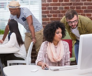 Creative business people using computer
