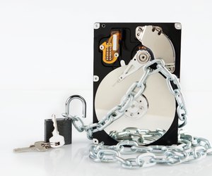 Unlocked padlock near of chained hard disk drive