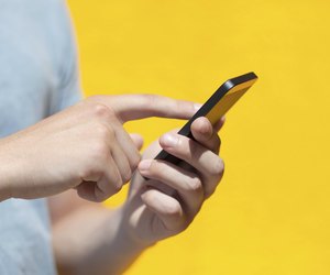 boy holding phone and a touch screen