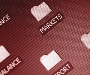 Investment folders on computer desktop, close-up, tilt