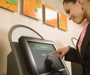 Businesswoman using self check-in terminal