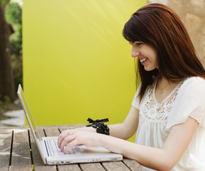 Woman working on a laptop and smiling