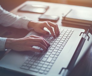 Working at home with laptop woman writing a blog. Female