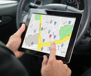 Person Sitting In A Car Using GPS Service