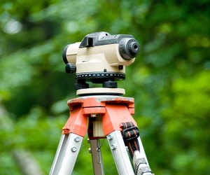 Close-up of theodolite atop tripod