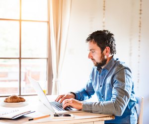 Man sitting at desk working from home on laptop