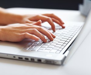 Businesswoman typing on laptop