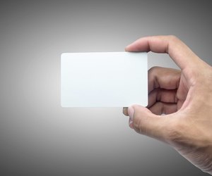 Hand holding card with empty space.