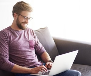 Handsome man using laptop at home
