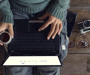 Man hands using Laptop and coffee cup
