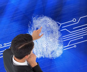 Composite image of thoughtful asian businessman pointing
