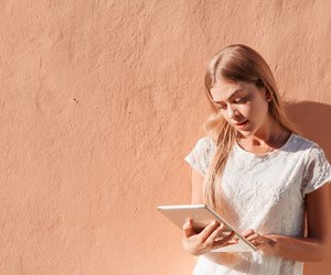 Elegant young woman using tablet