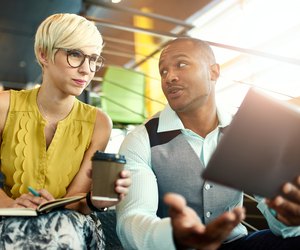 Two creative millenial small business owners working on social media