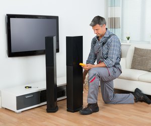 Technician Checking TV Speaker With Multimeter