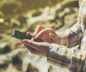 Female tourist using mobile smart phone for GPS navigation