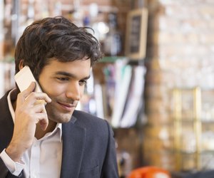Handsome man calling with a cell phone in coffee bar